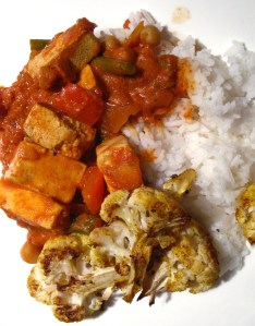 Butter tofu served with rice and roasted cauliflower.
